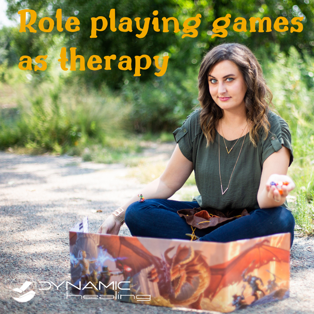 Cheryl is sitting on the ground behind a 5th edition dungeon master's screen, holding out a handful of dice with an ominous smirk on her face. The words "Role playing games as therapy" are floating over her head and "Dynamic Healing" in the bottom, left corner.